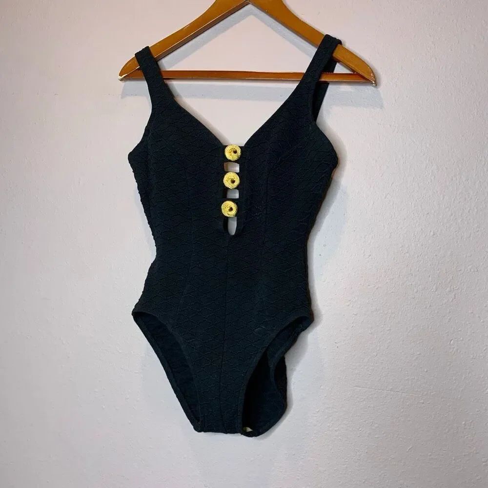 Mainstream vintage one-piece swimsuit features a textured fabric and gold button